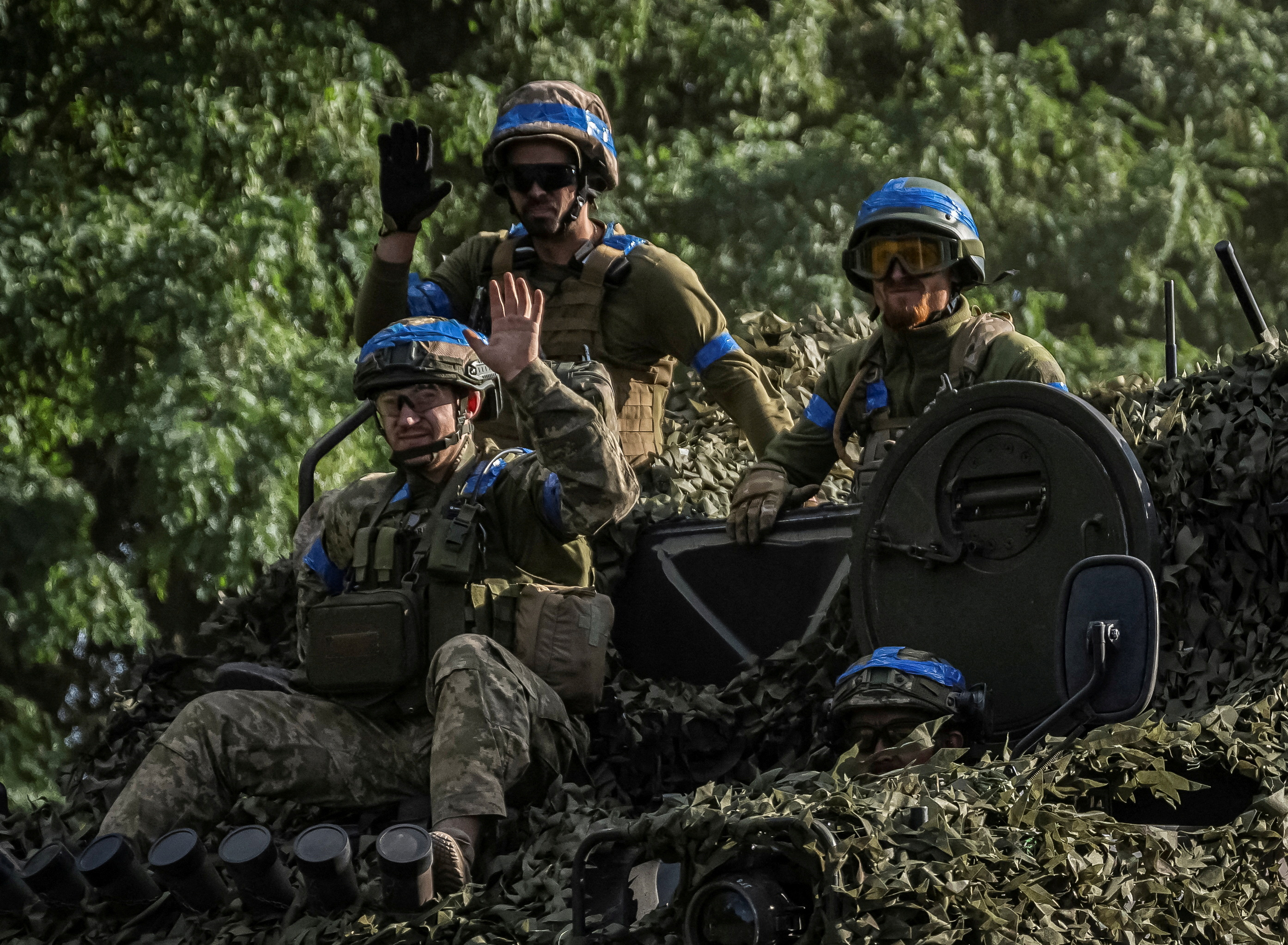 FILE PHOTO: Ukrainian service members ride an Armoured Personnel Carrier near the Russian border in Sumy region