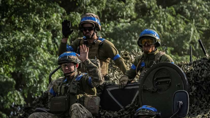 FILE PHOTO: Ukrainian service members ride an Armoured Personnel Carrier near the Russian border in Sumy region
