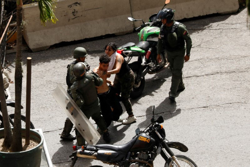 FILE PHOTO: Bolivarian National Guard detain demonstrators, in Caracas