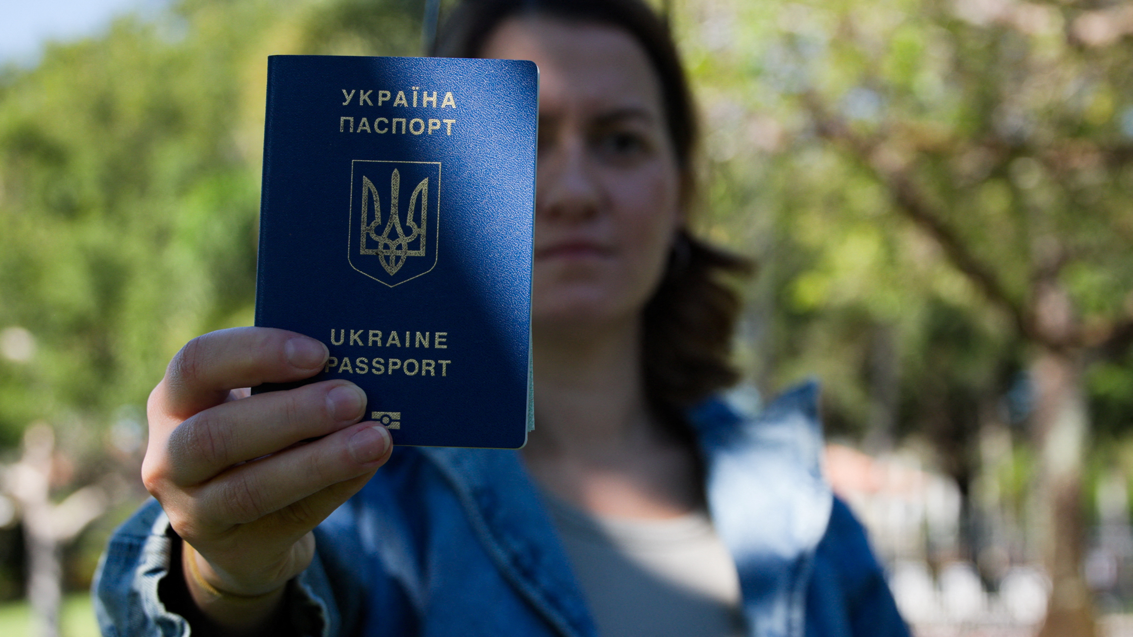 Kateryna Golizdra holds her Ukrainian passport for a photograph outside her home in Margate