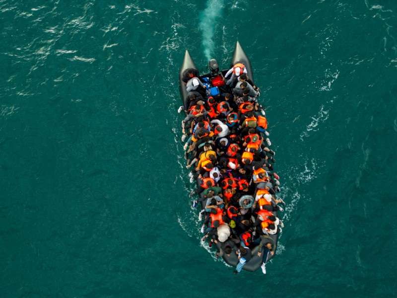 Migrants cross the English Channel in small boats