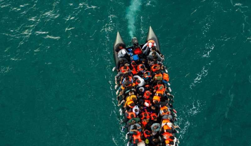 Migrants cross the English Channel in small boats