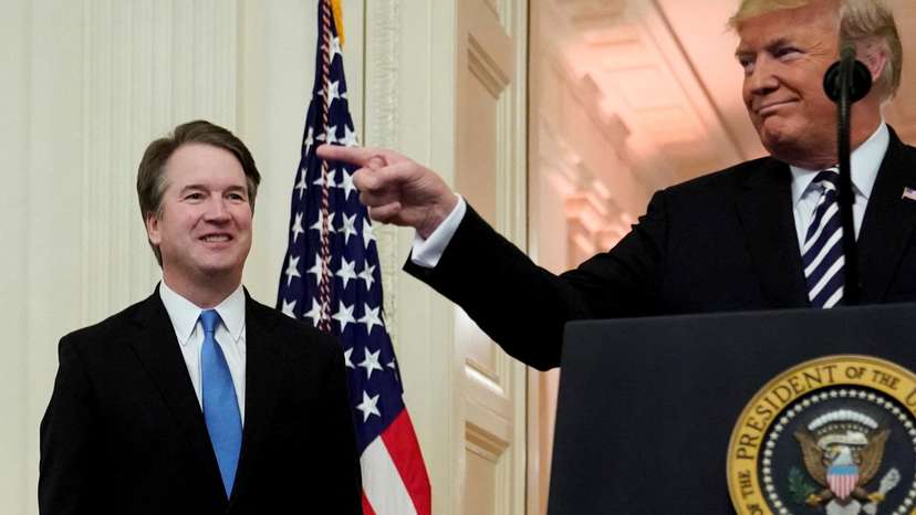 FILE PHOTO: U.S. President Donald Trump speaks next to U.S. Supreme Court Associate Justice Brett Kavanaugh as they participate in a ceremonial public swearing-in at the East Room of the White House in Washington