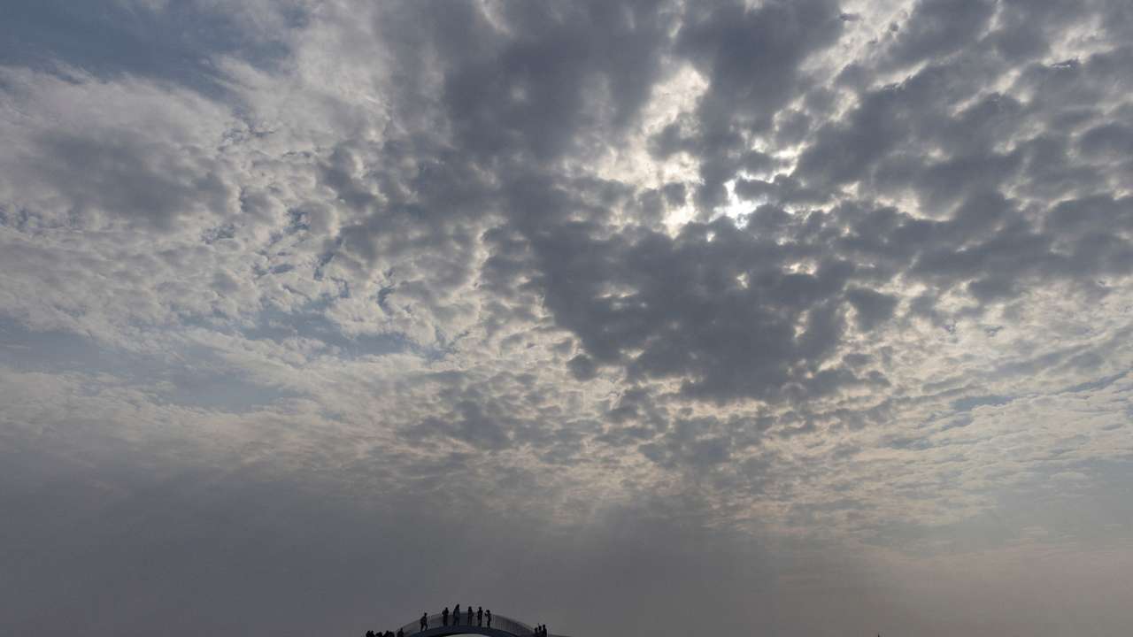 FILE PHOTO: People stand on a viewing platform overlooking the Taiwan strait at the 68-nautical-mile scenic spot, one of mainland China's closest points to the island of Taiwan, on Pingtan Island