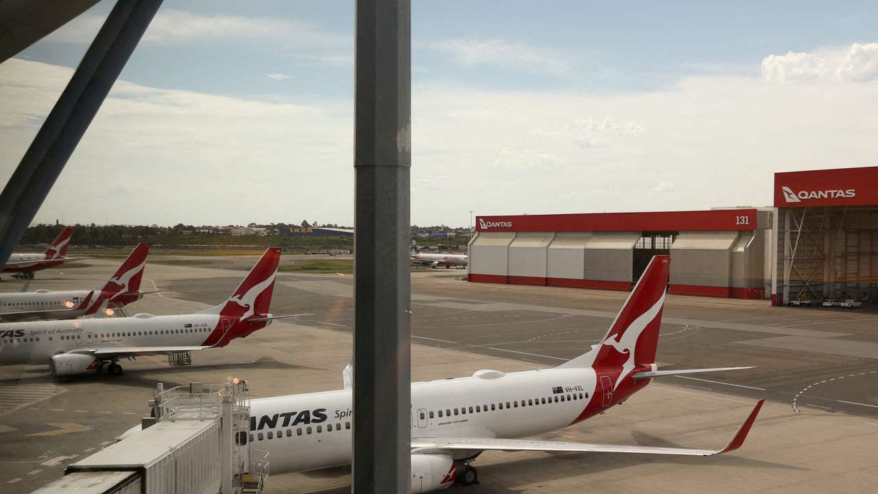 FILE PHOTO: Qantas planes are seen at a domestic terminal at Sydney Airport in Sydney