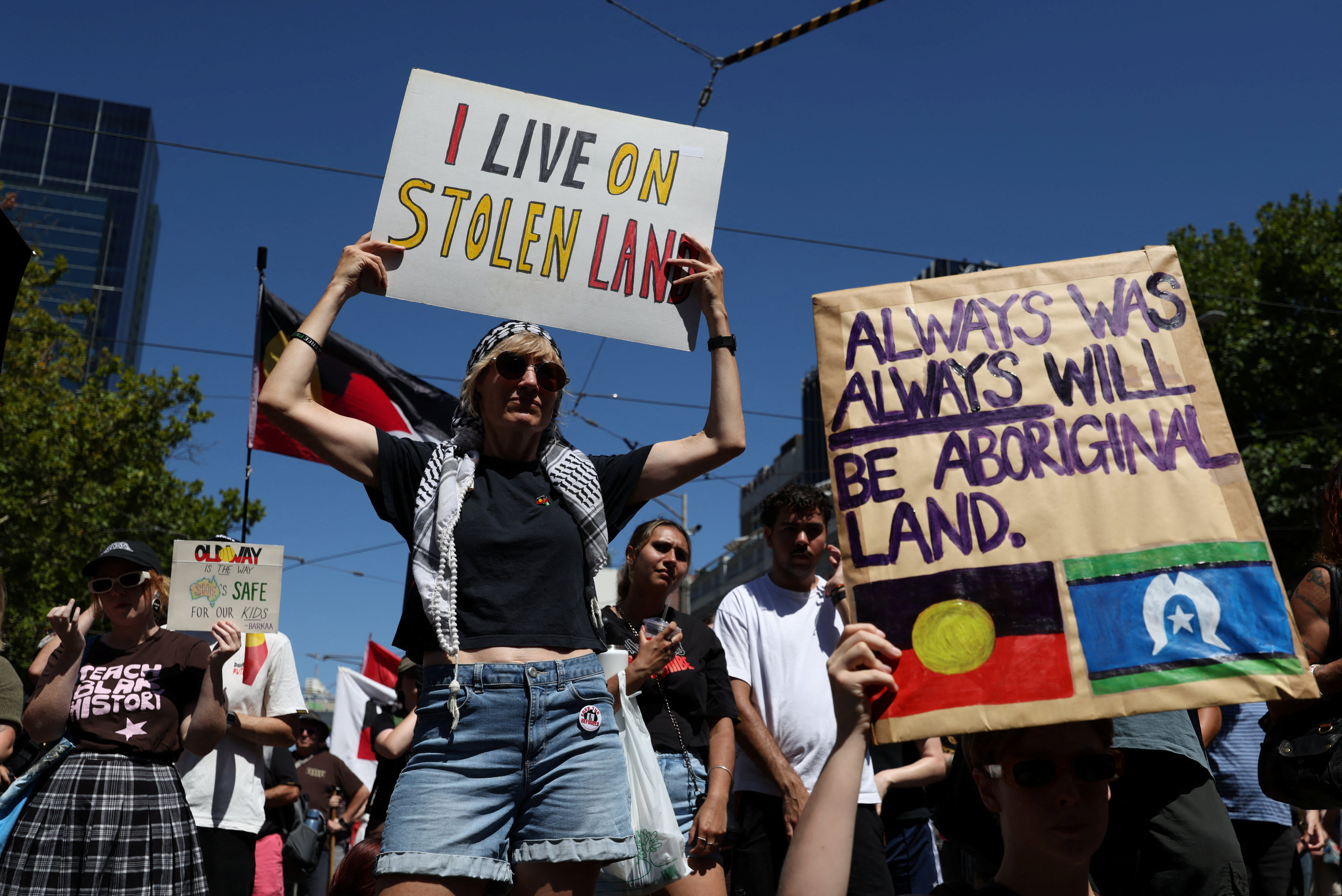 Protestors attend an "Invasion Day" rally on Australia Day, in Melbourne