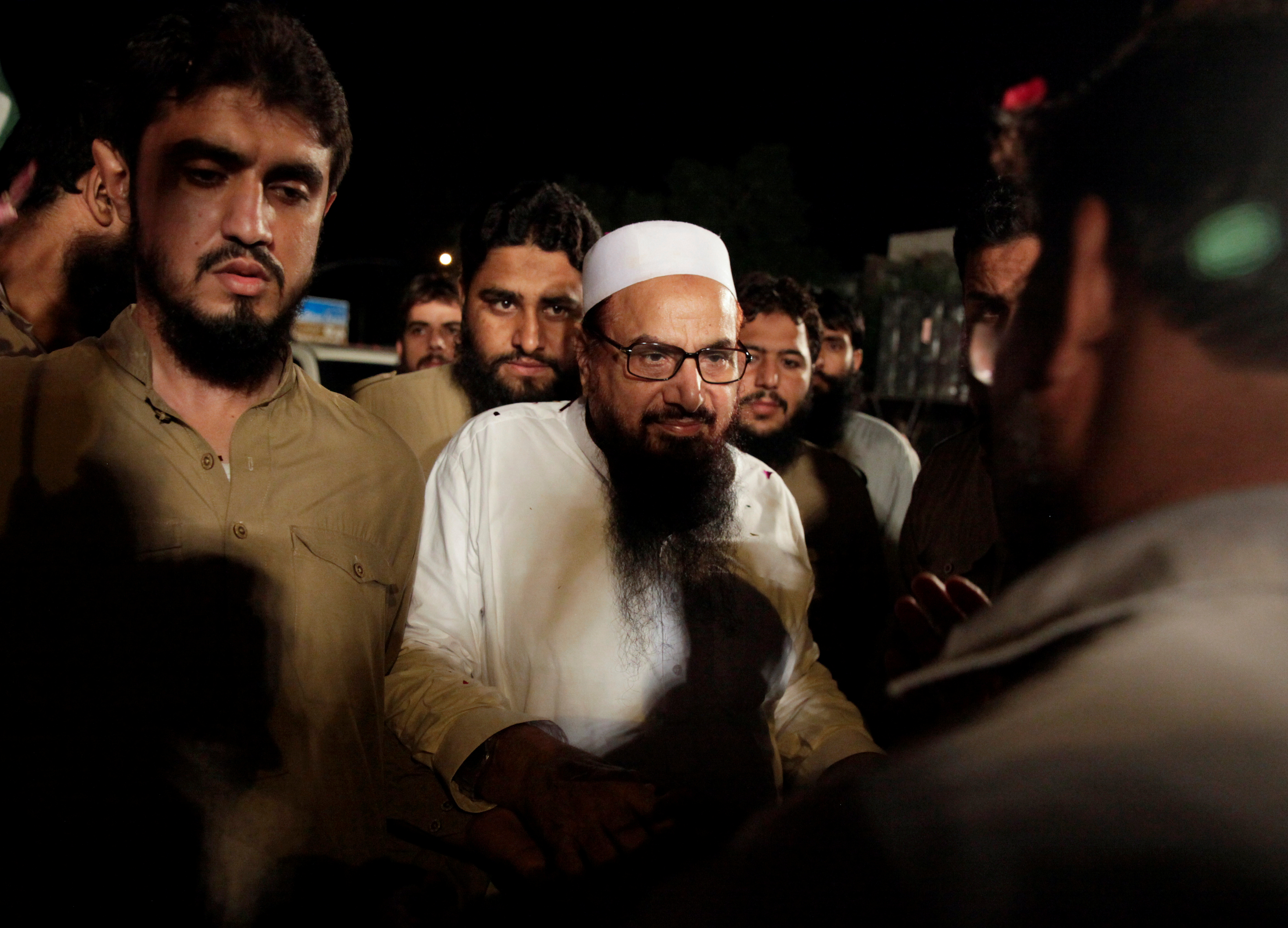 FILE PHOTO: Hafiz Muhammad Saeed, chief of the Islamic charity organisation Jamaat-ud-Dawa (JuD), arrives to attend a campaign rally of political party, Milli Muslim League (MML), ahead of general elections in Islamabad,
