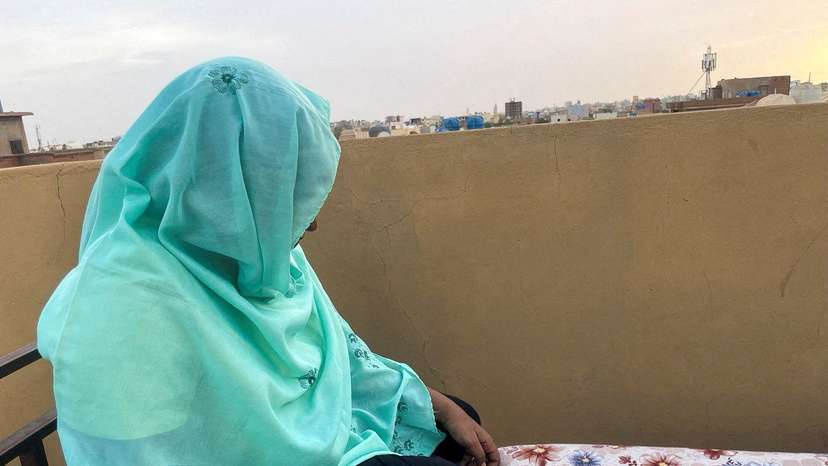 FILE PHOTO: Heba checks her phone for news of her relatives at her house during the conflict in Khartoum
