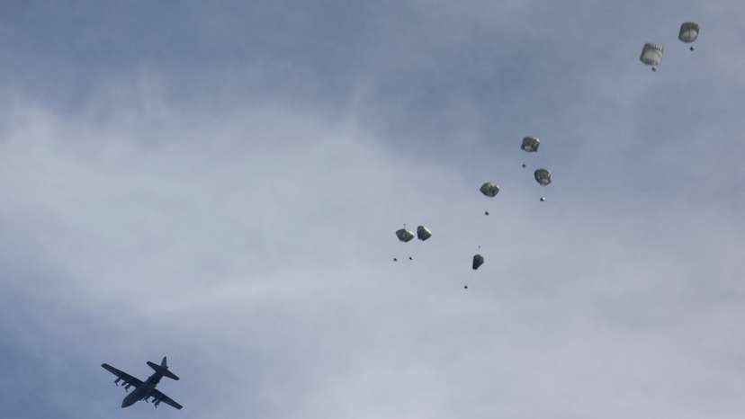 A plane drops aid over Gaza, amid the ongoing the conflict between Israel and Hamas, in Gaza City