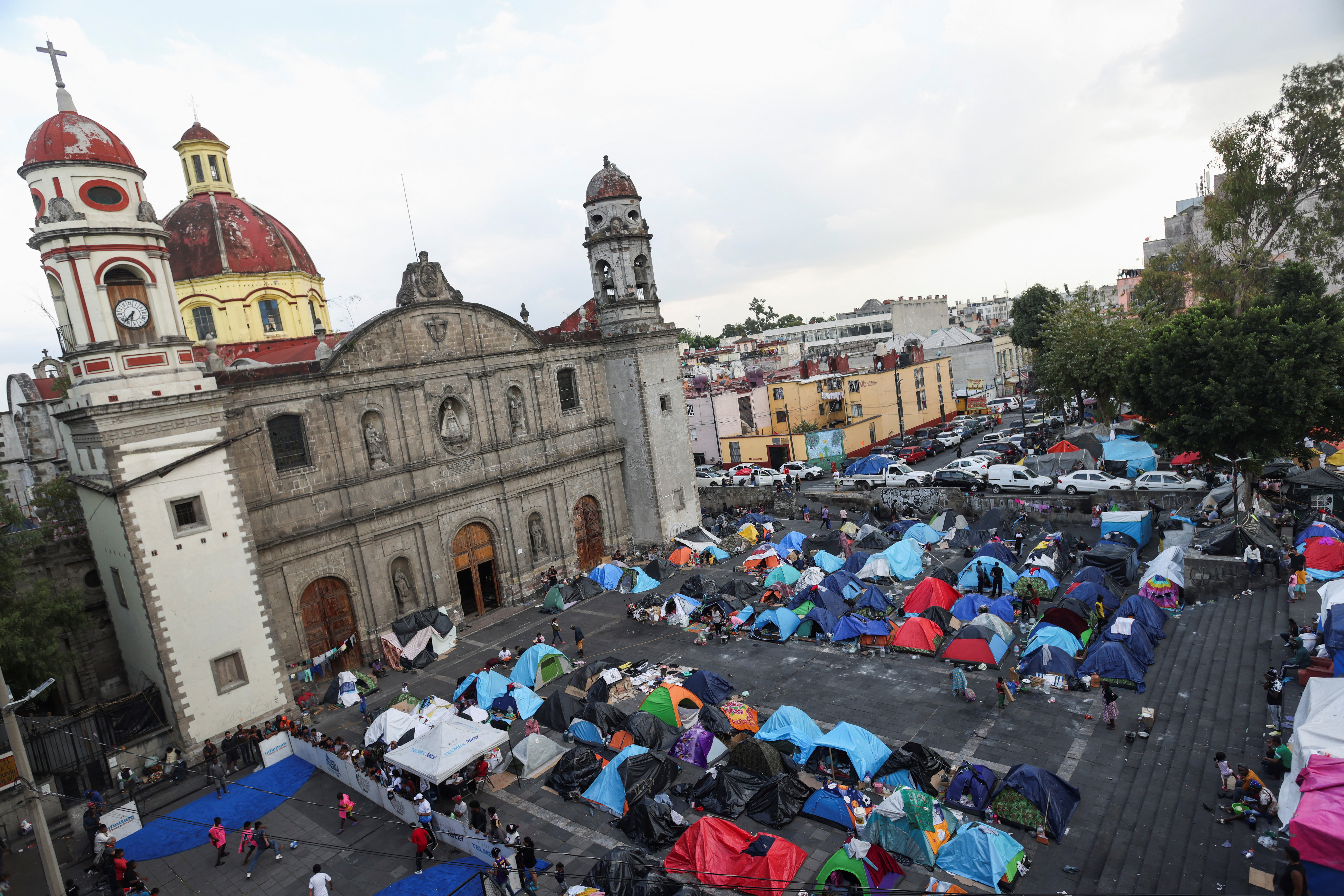 Migrants crowd Mexico City church in bustling makeshift shelter