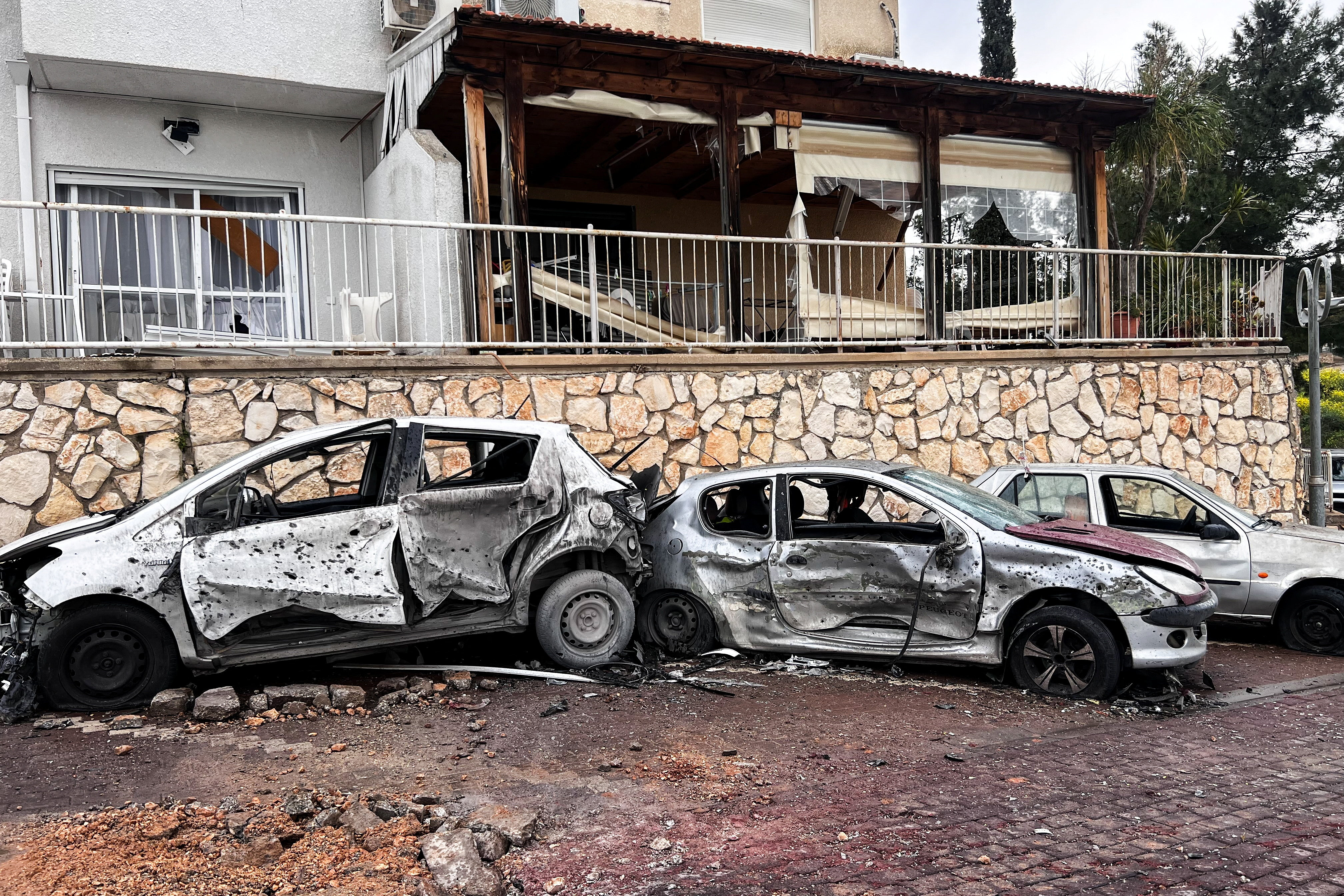 Damaged vehicles and buildings after projectile was launched towards Israel from the Iran-backed Hezbollah in Lebanon, in northern Israel