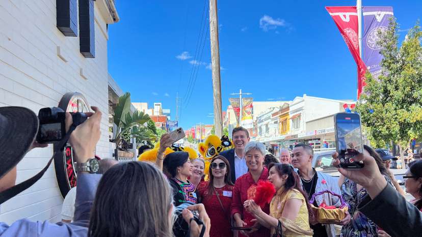 Australia's Labour party MP for Bennelong Jerome Laxale and Australian Foreign Minister Penny Wong pose for pictures with residents at Eastwood in Sydney