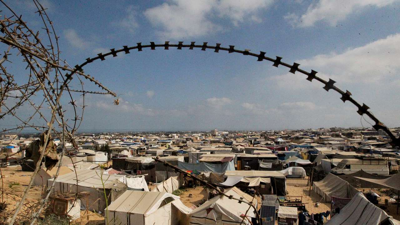 Displaced Palestinians shelter in a tent camp, in Rafah