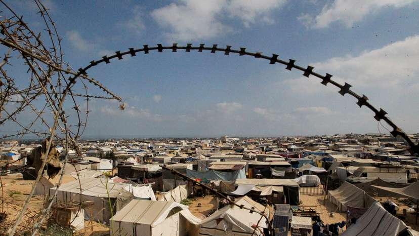 Displaced Palestinians shelter in a tent camp, in Rafah