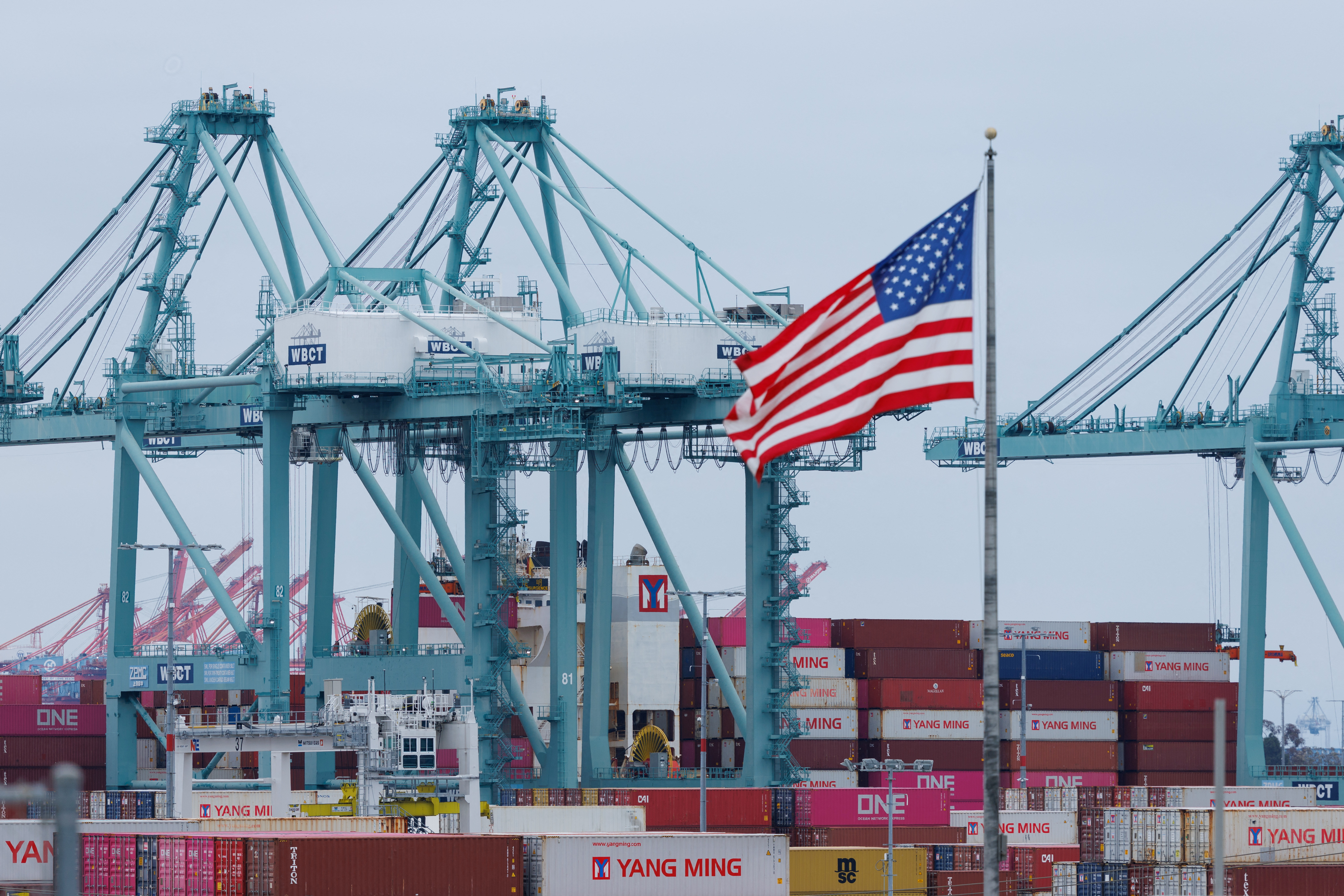 Shipping containers are unloaded at the Port of Los Angeles, in San Pedro