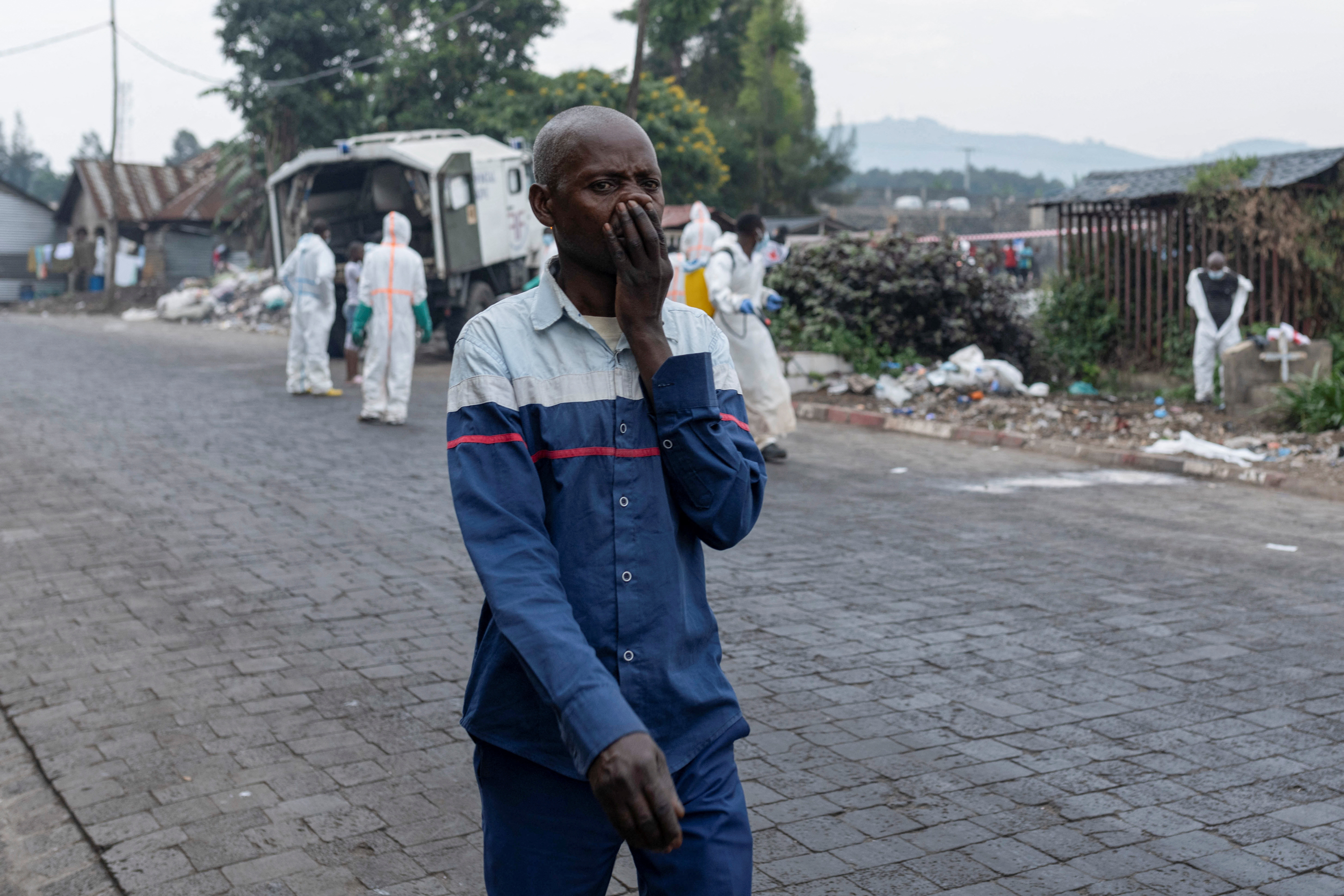 Red Cross team members proceed with the burial of victims of the fighting, in Goma