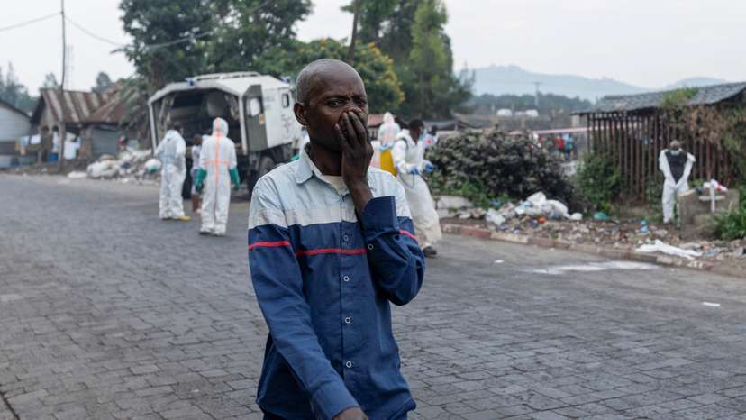 Red Cross team members proceed with the burial of victims of the fighting, in Goma