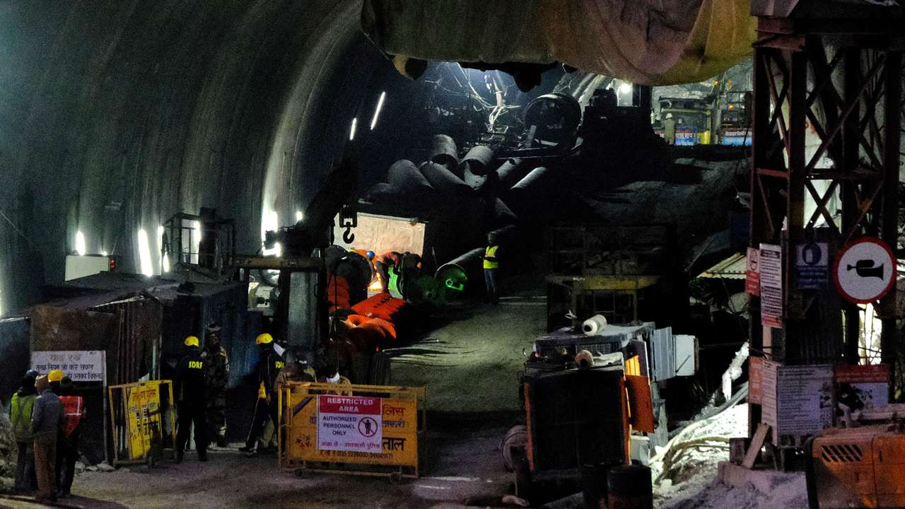 Members of rescue teams use an auger inside a tunnel where workers have been trapped for ten days after the tunnel collapsed in Uttarkashi