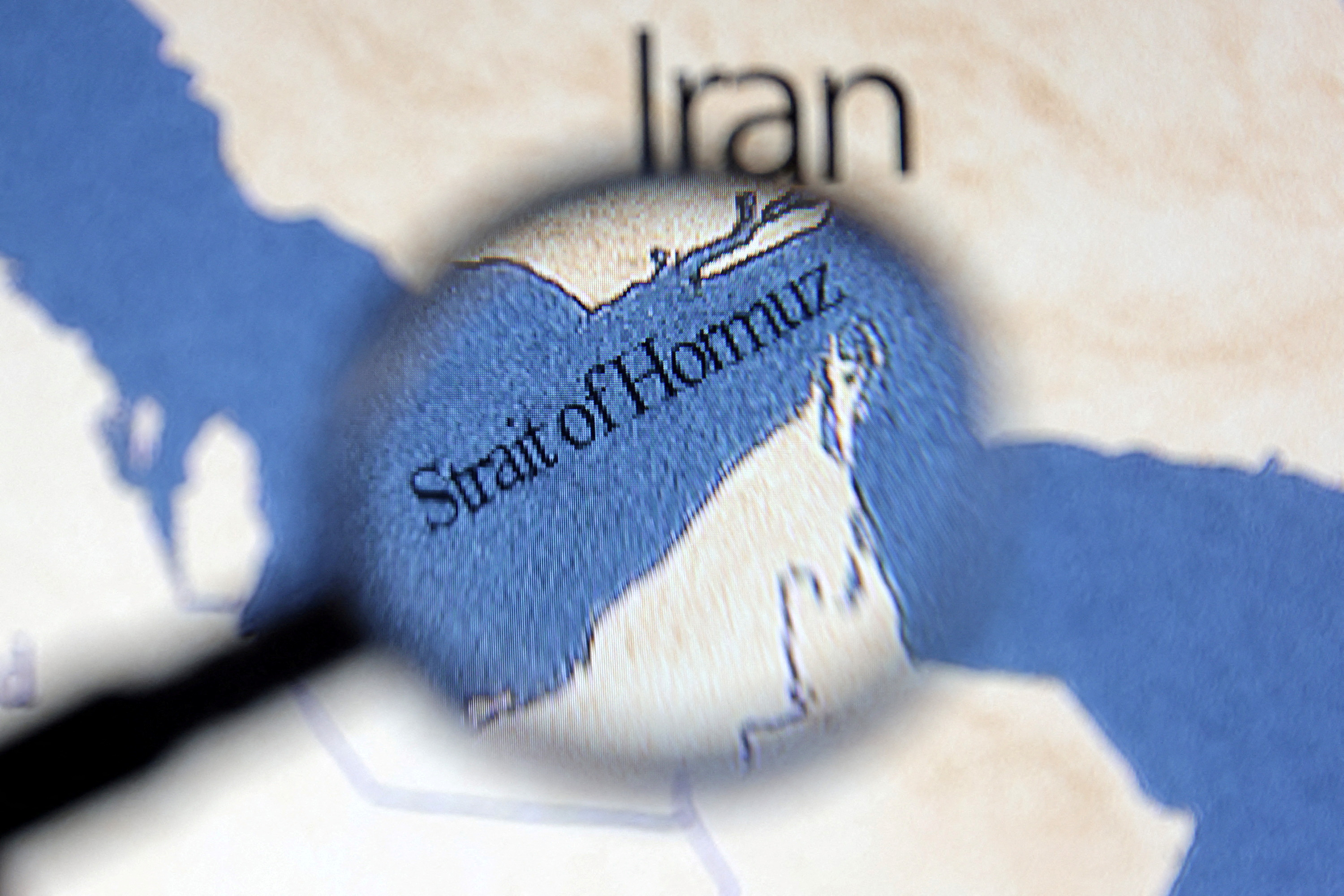 Illustration shows map showing the Strait of Hormuz and Iran