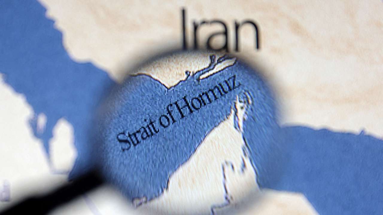 Illustration shows map showing the Strait of Hormuz and Iran