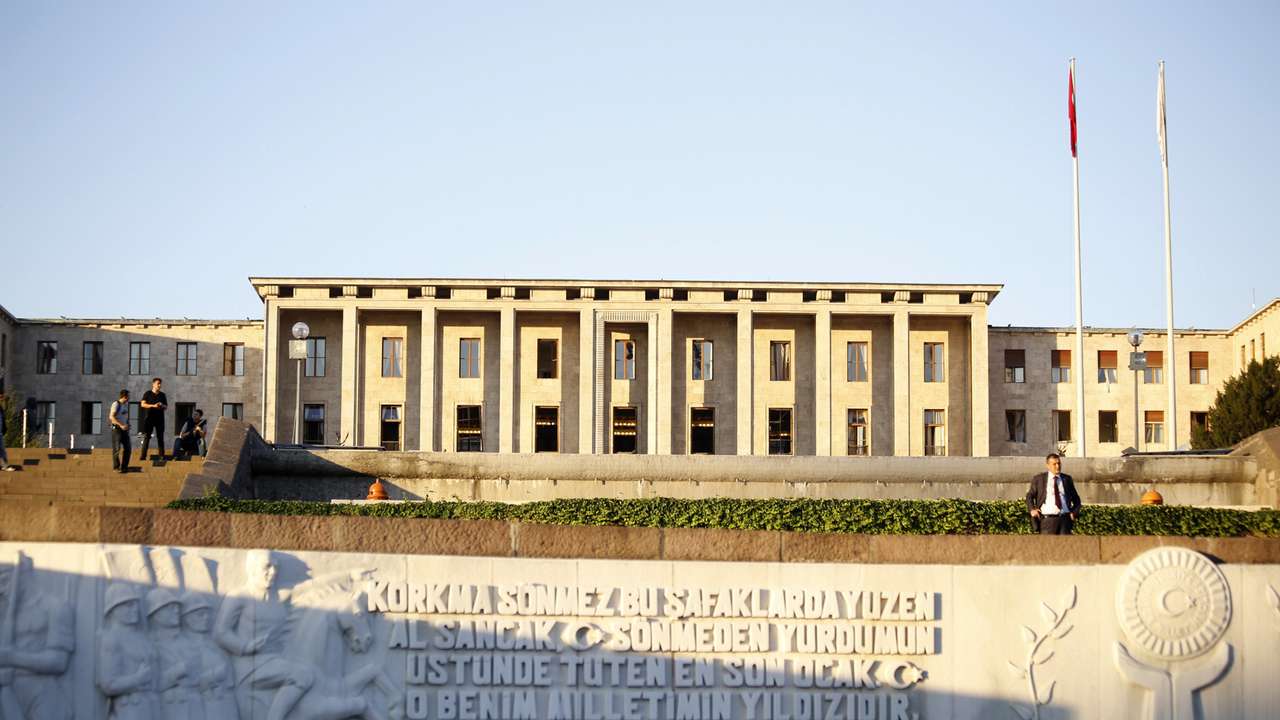 People are pictured outside the parliament building in Ankara