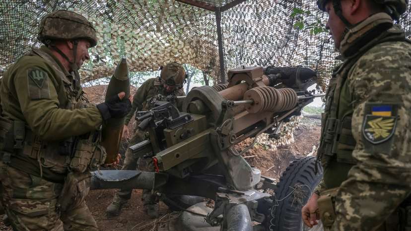 Ukrainian service members fire a L119 howitzer in Donetsk region