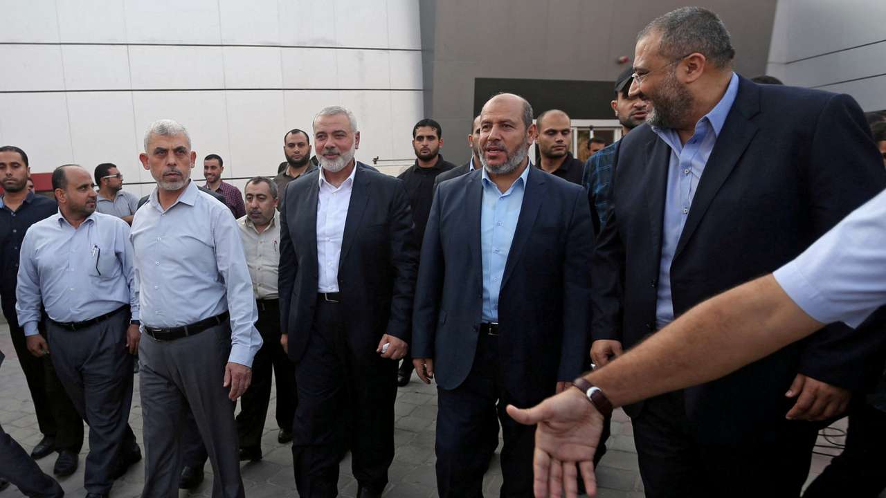 FILE PHOTO: Hamas Gaza Chief Yahya Al-Sinwar, Hamas Chief Ismail Haniyeh and senior Hamas leader Khalil al-Hayya arrive at the Rafah border crossing in the southern Gaza Strip