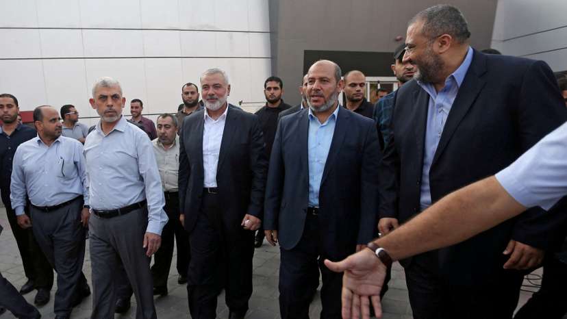 FILE PHOTO: Hamas Gaza Chief Yahya Al-Sinwar, Hamas Chief Ismail Haniyeh and senior Hamas leader Khalil al-Hayya arrive at the Rafah border crossing in the southern Gaza Strip