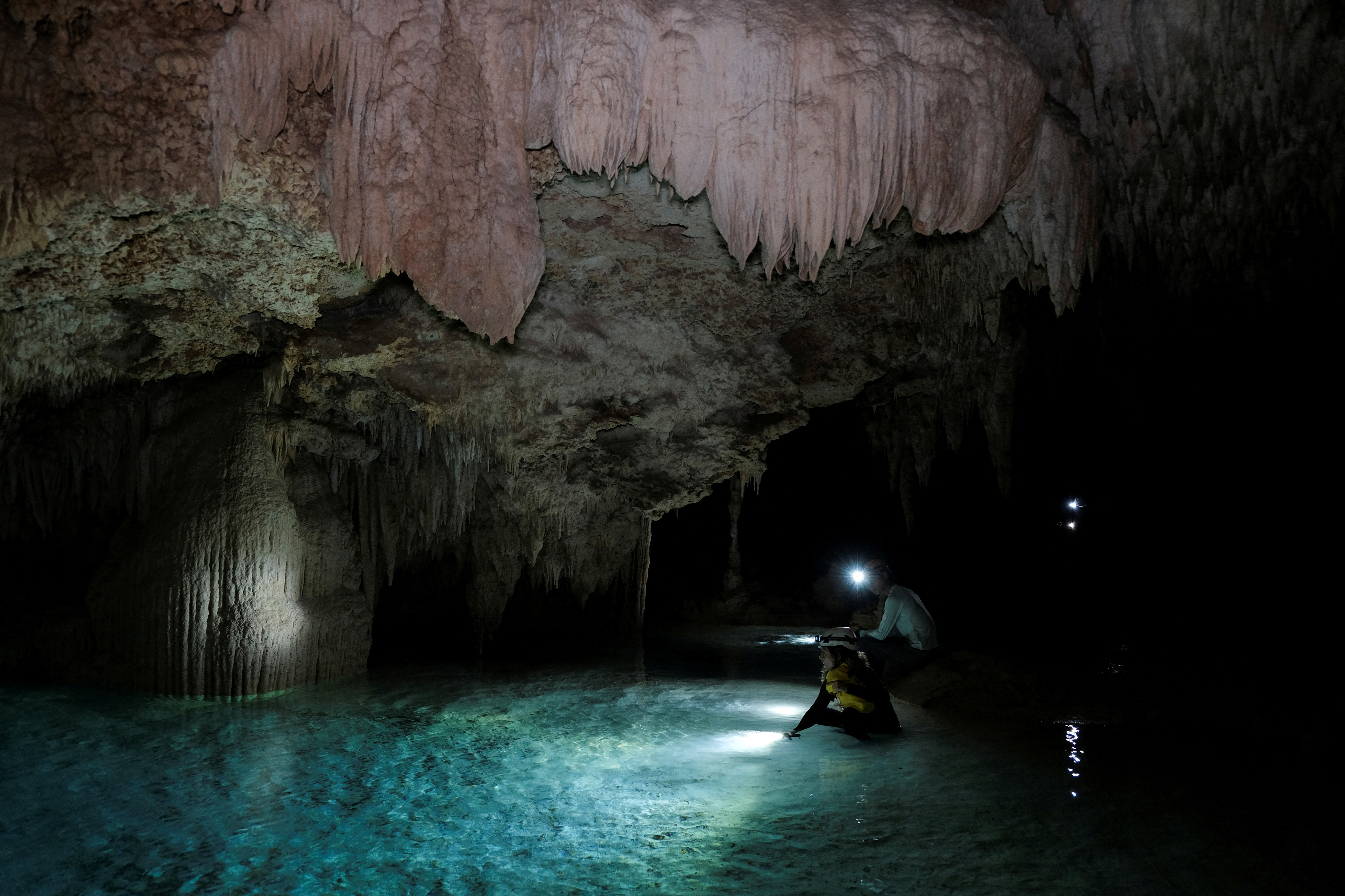 Activists from the group Cenotes Urbanos explore the underground caves of the Aktun T'uyul System, in Playa del Carmen
