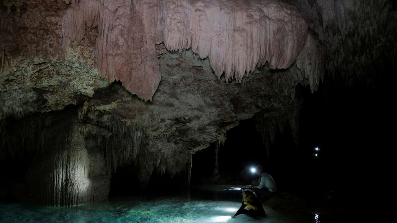 Activists from the group Cenotes Urbanos explore the underground caves of the Aktun T'uyul System, in Playa del Carmen