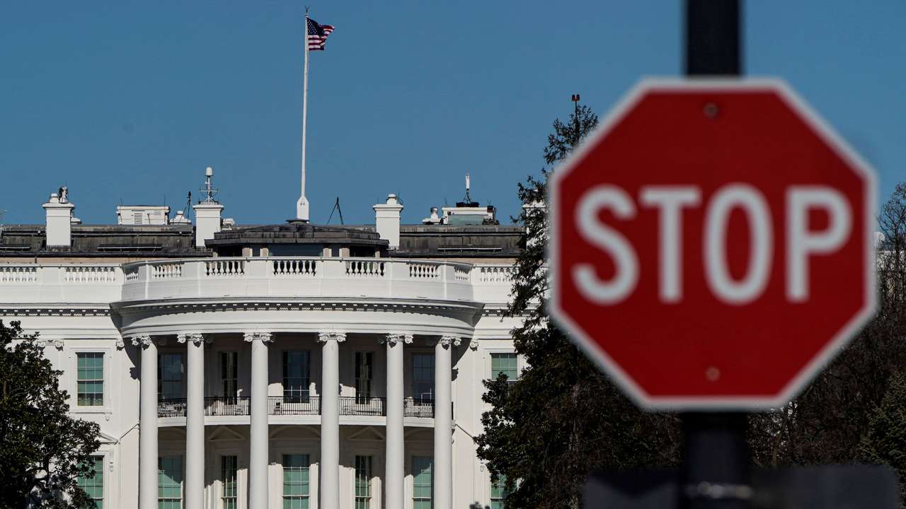 FILE PHOTO: The White House is seen behind a stop sign in Washington