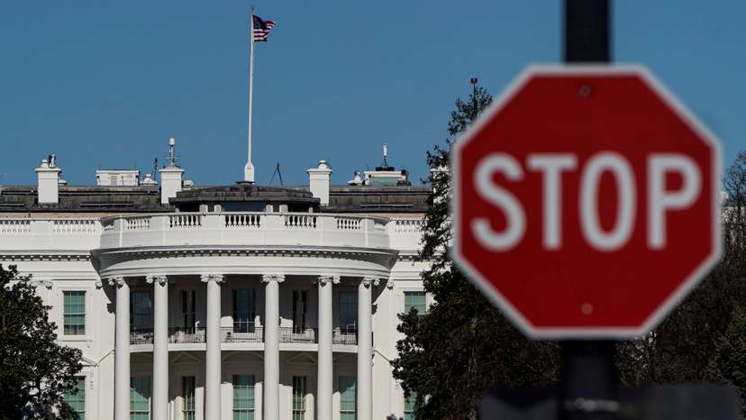FILE PHOTO: The White House is seen behind a stop sign in Washington
