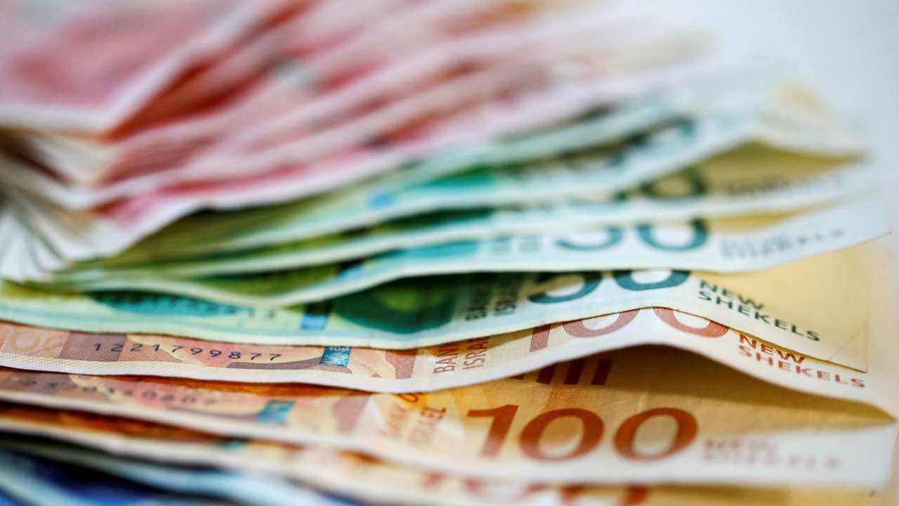FILE PHOTO: New Israeli Shekel banknotes are seen in this picture illustration