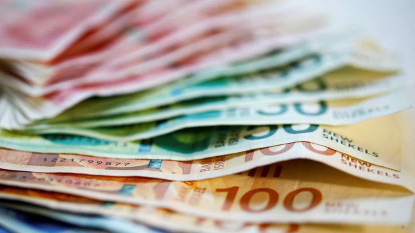FILE PHOTO: New Israeli Shekel banknotes are seen in this picture illustration