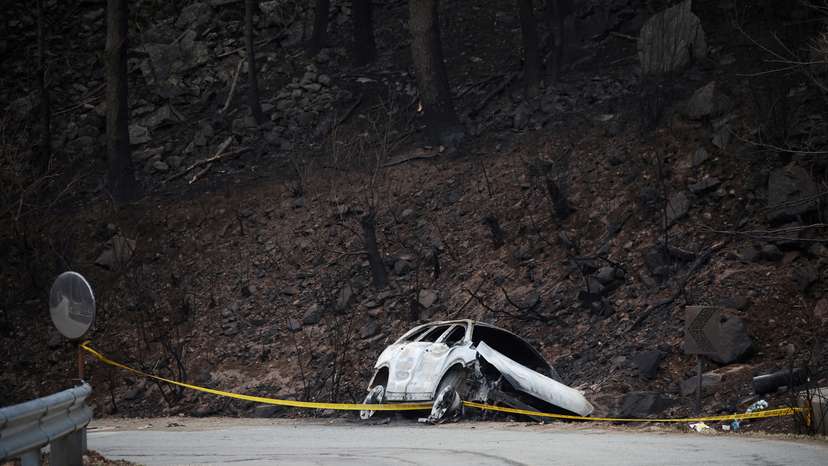 A burnt vehicle, in which a village leader Kwon and his wife were found dead while they were on their way back to their village to rescue other people during a wildfire, lies on the side of a road in Yeongyang