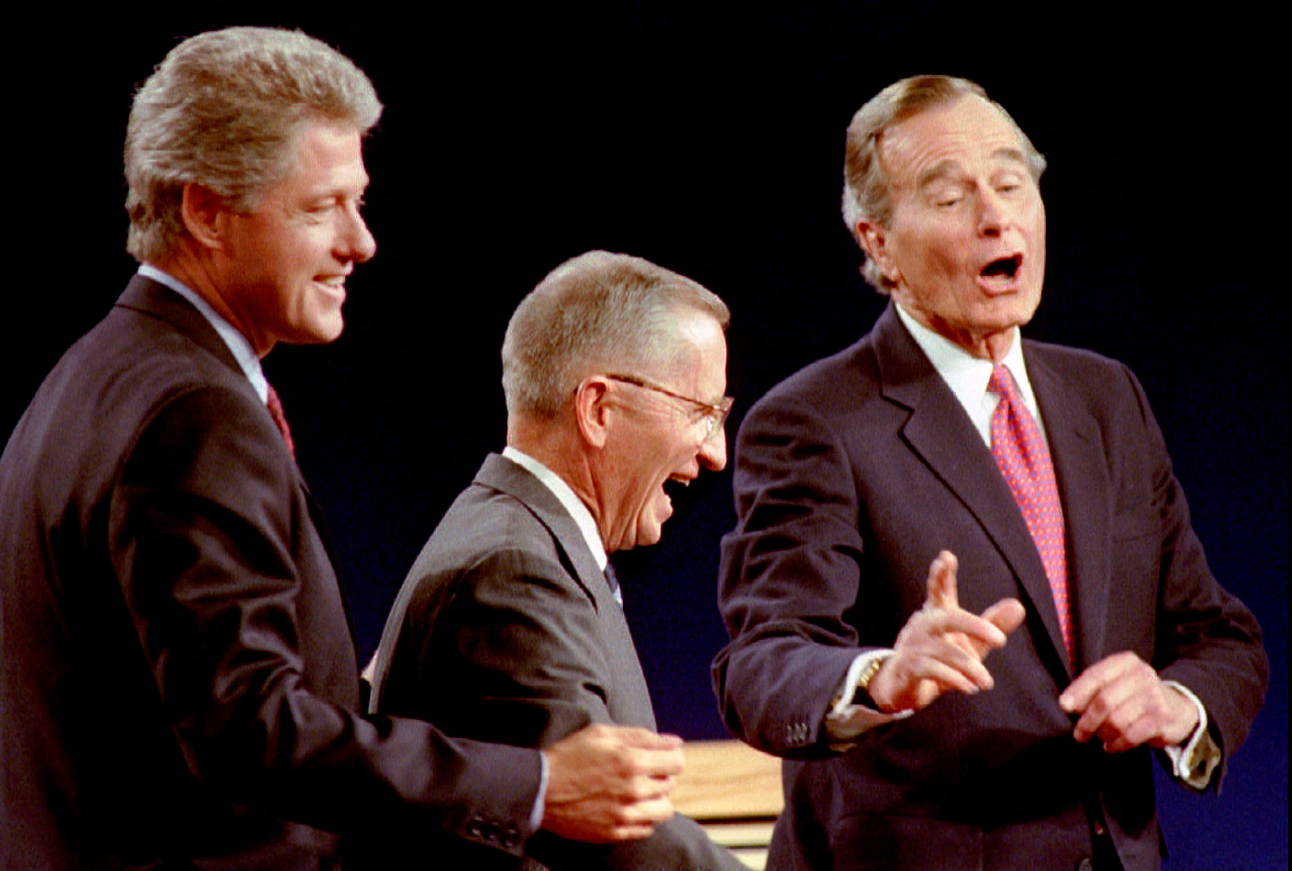 FILE PHOTO: Clinton, Perot and Bush laugh at the conclusion of their 1992 Presidential debate in East Lansing