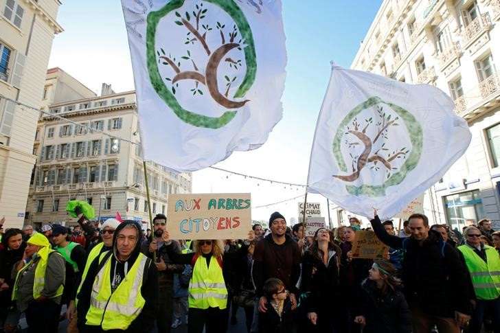 People attend a demonstration to urge politicians to act against climate change in Marseille