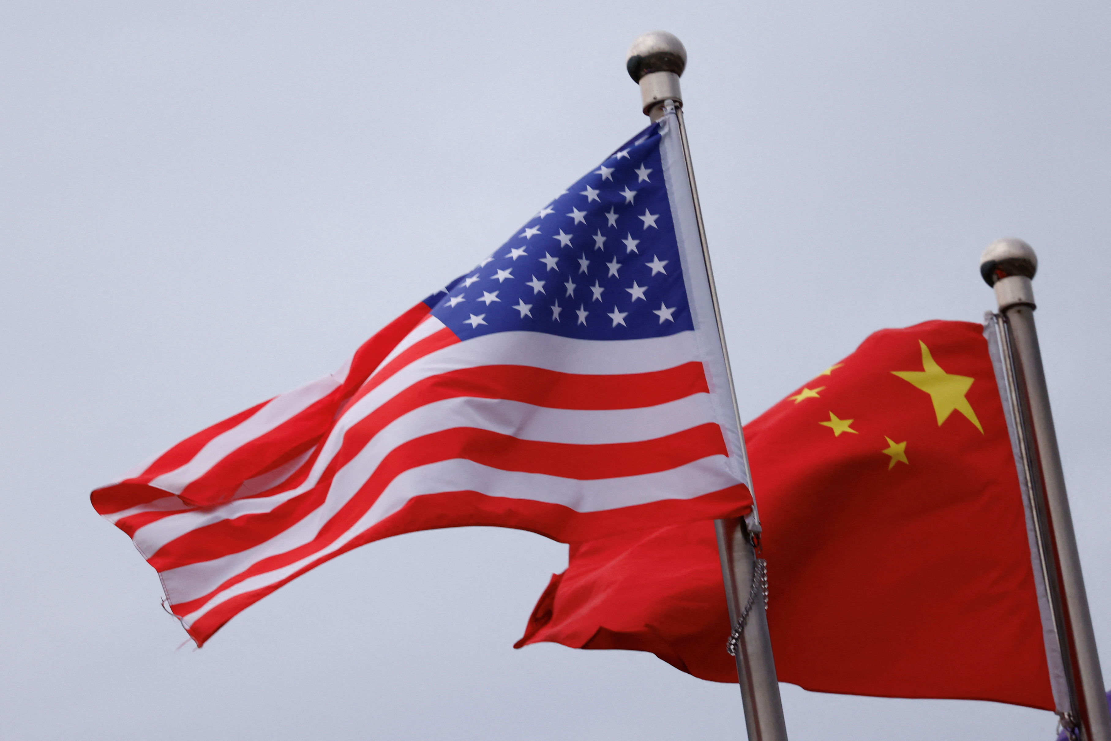 Chinese and U.S. flags flutter outside the building of an American company in Beijing