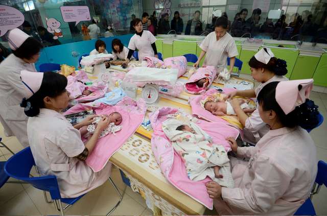 FILE PHOTO: Infants undergo a daily medical examination at a maternal and child health care hospital in Taiyuan