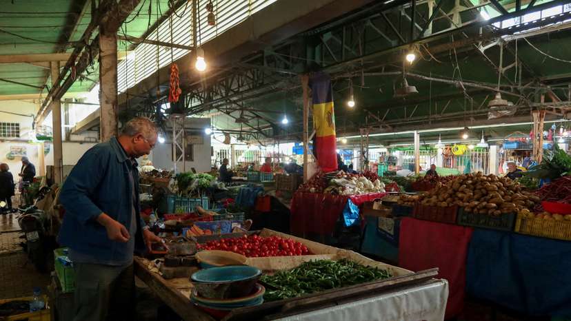 People shop at a market in Tunis