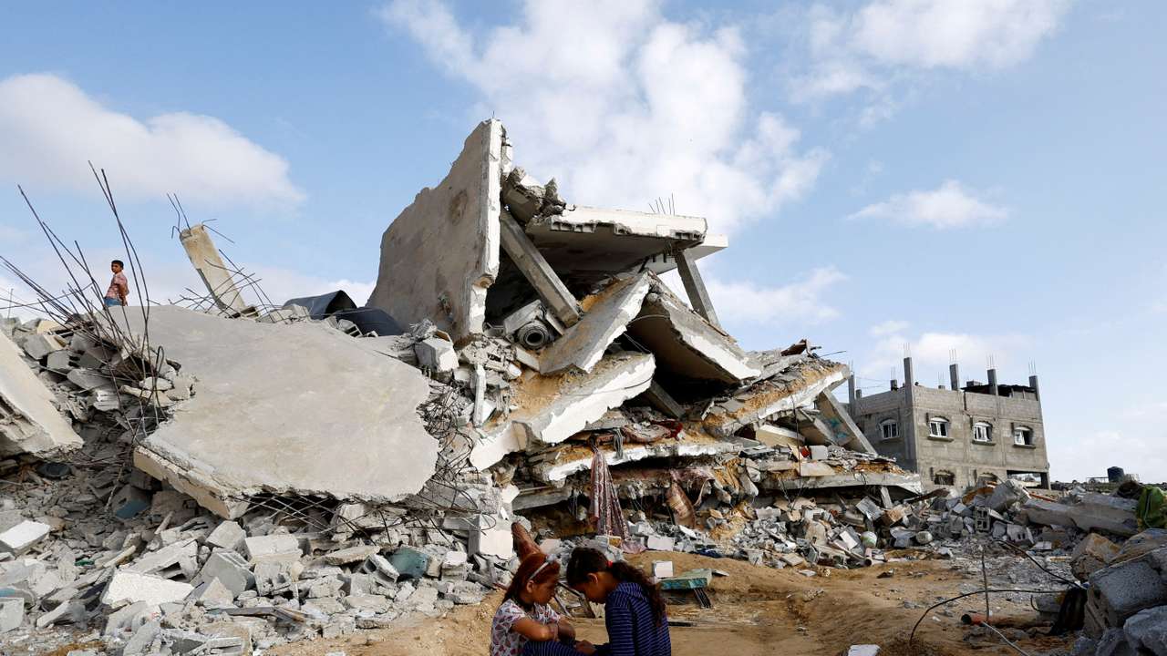 FILE PHOTO: Palestinian children sit next to the site of an Israeli strike on a house, in Rafah