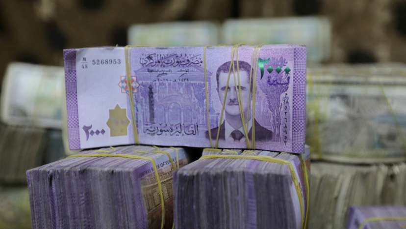 FILE PHOTO: Syrian pounds are pictured inside an exchange currency shop in Azaz