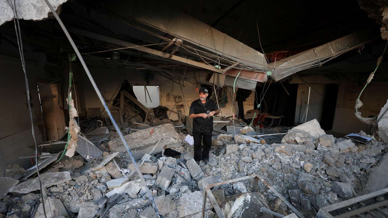 Palestinians inspect damage inside the Al-Ahli Arab Baptist Hospital in Gaza City