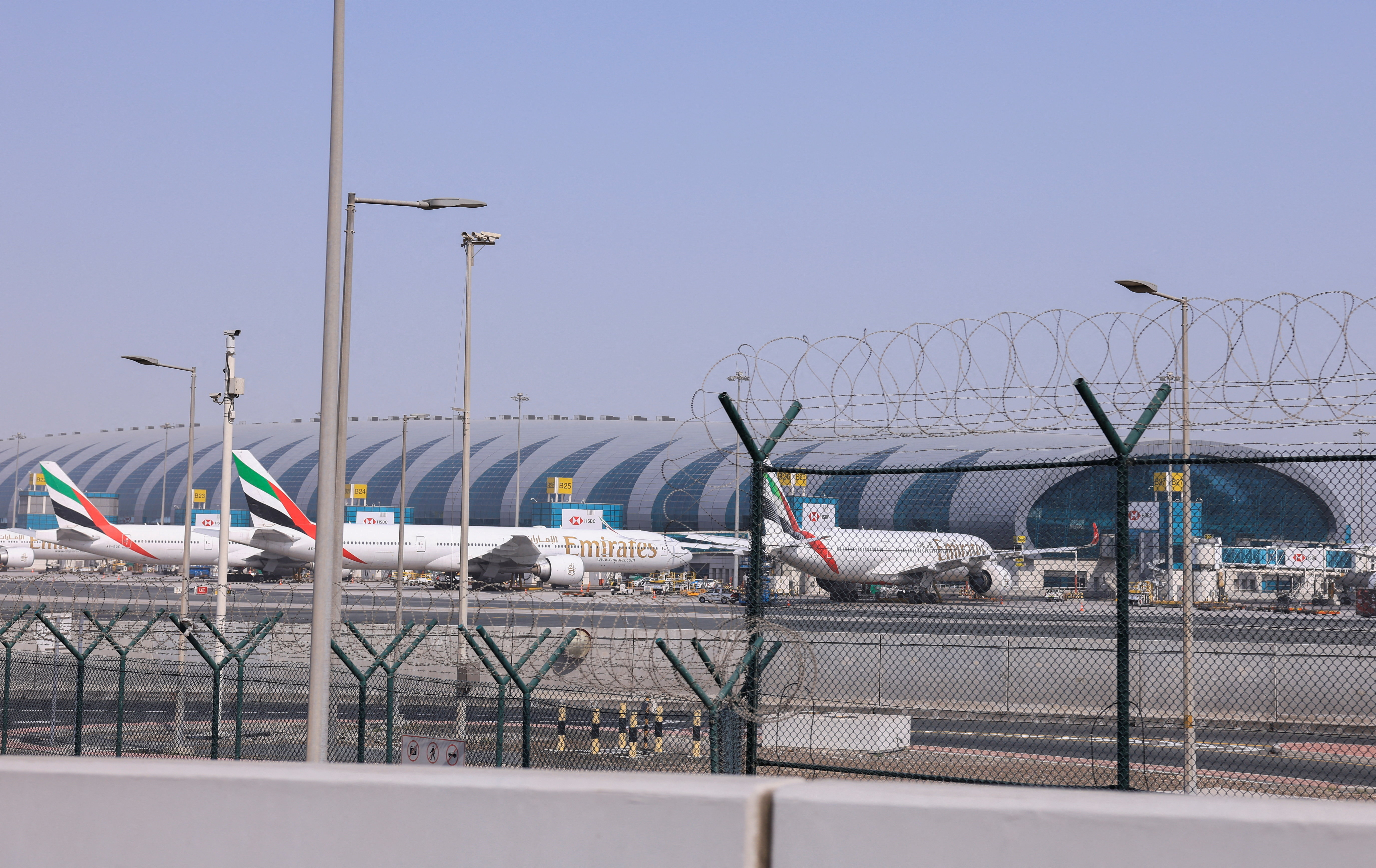 Planes are parked at Terminal 3 of the Dubai International Airport
