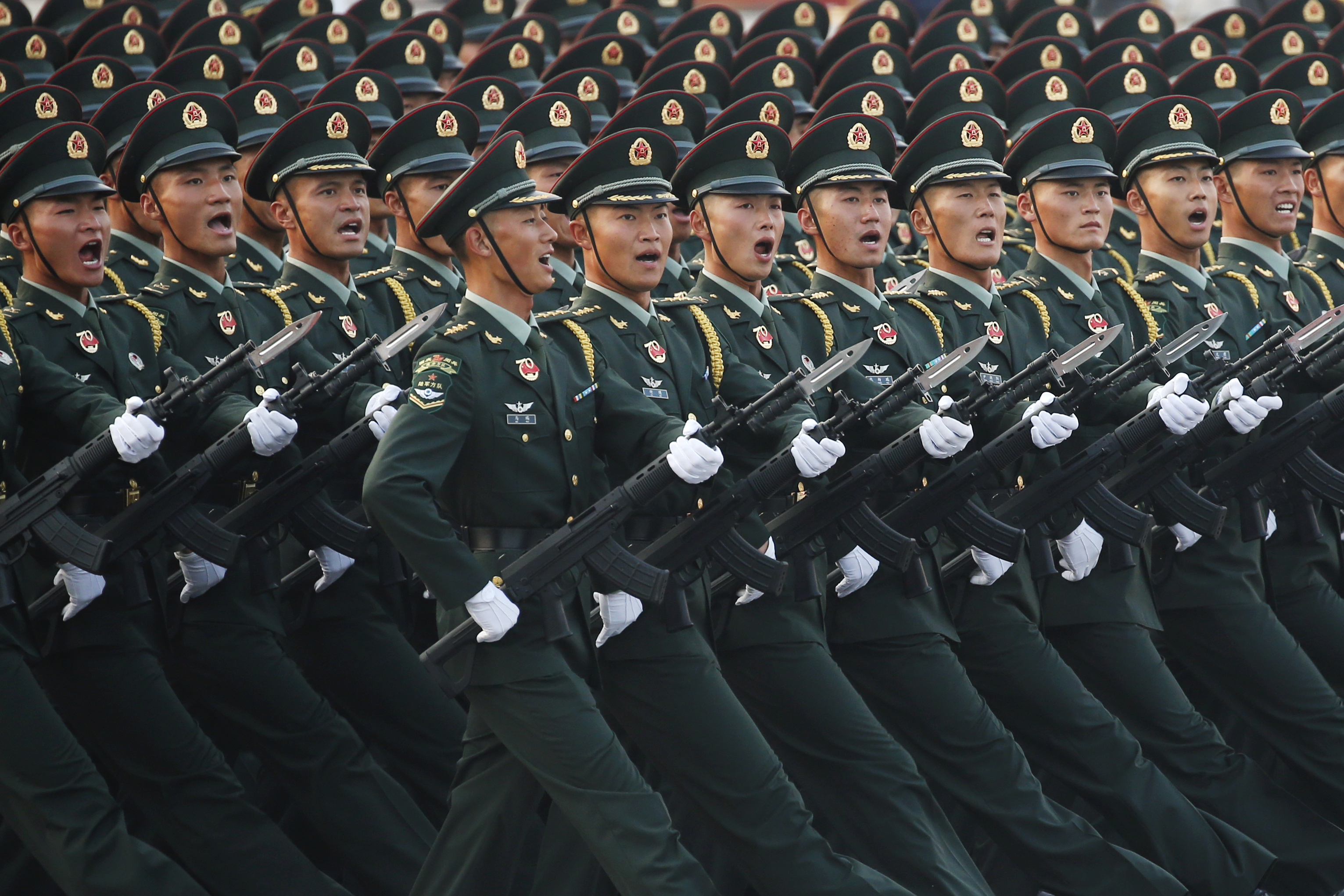FILE PHOTO: Soldiers of People's Liberation Army (PLA) march in formation past Tiananmen Square during a rehearsal before a military parade marking the 70th founding anniversary of People's Republic of China