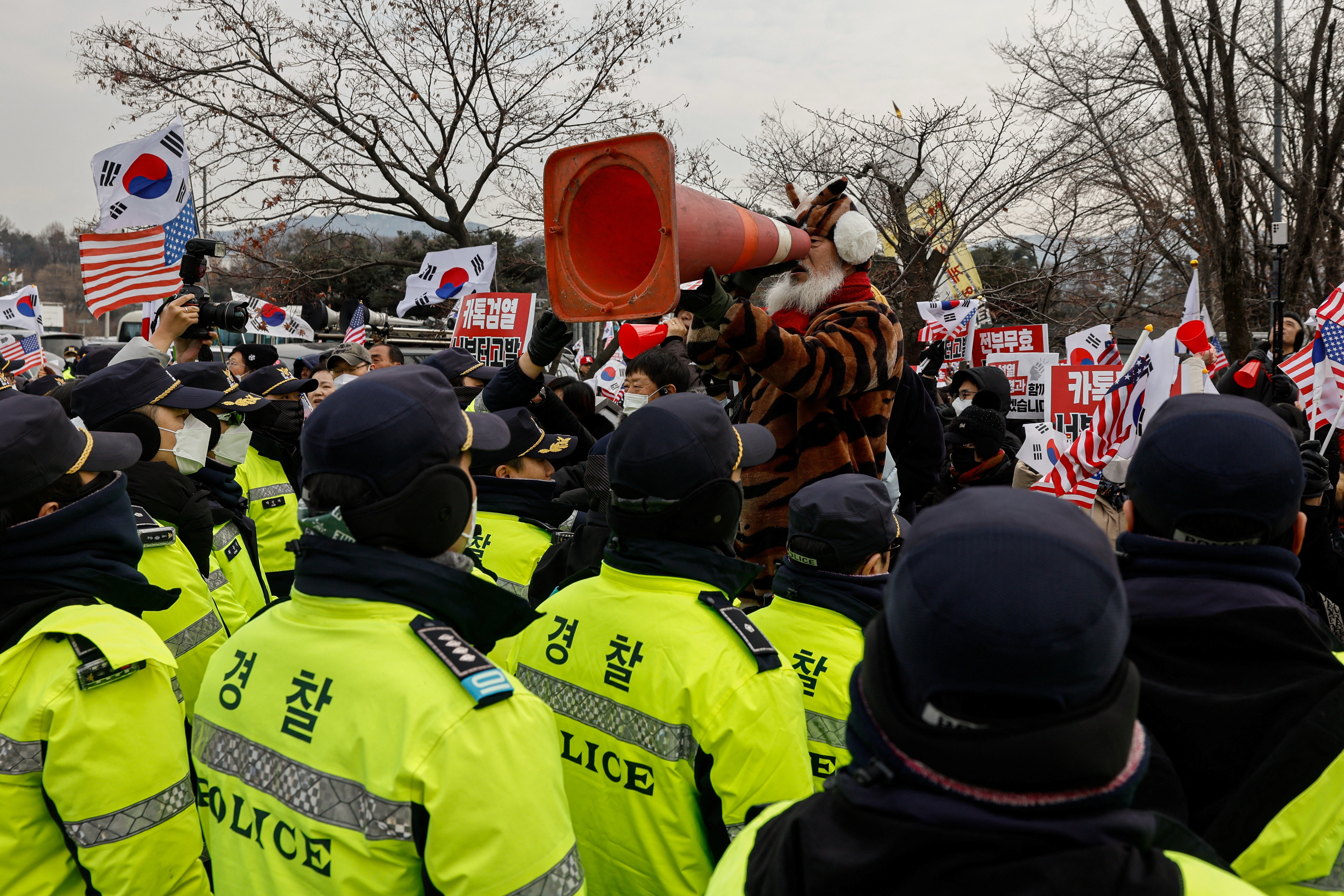 Pro-Yoon supporters shout while expressing their stance on the media’s coverage during a rally outside the Seoul Detention Center in Uiwang