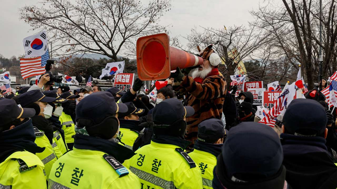 Pro-Yoon supporters shout while expressing their stance on the media’s coverage during a rally outside the Seoul Detention Center in Uiwang
