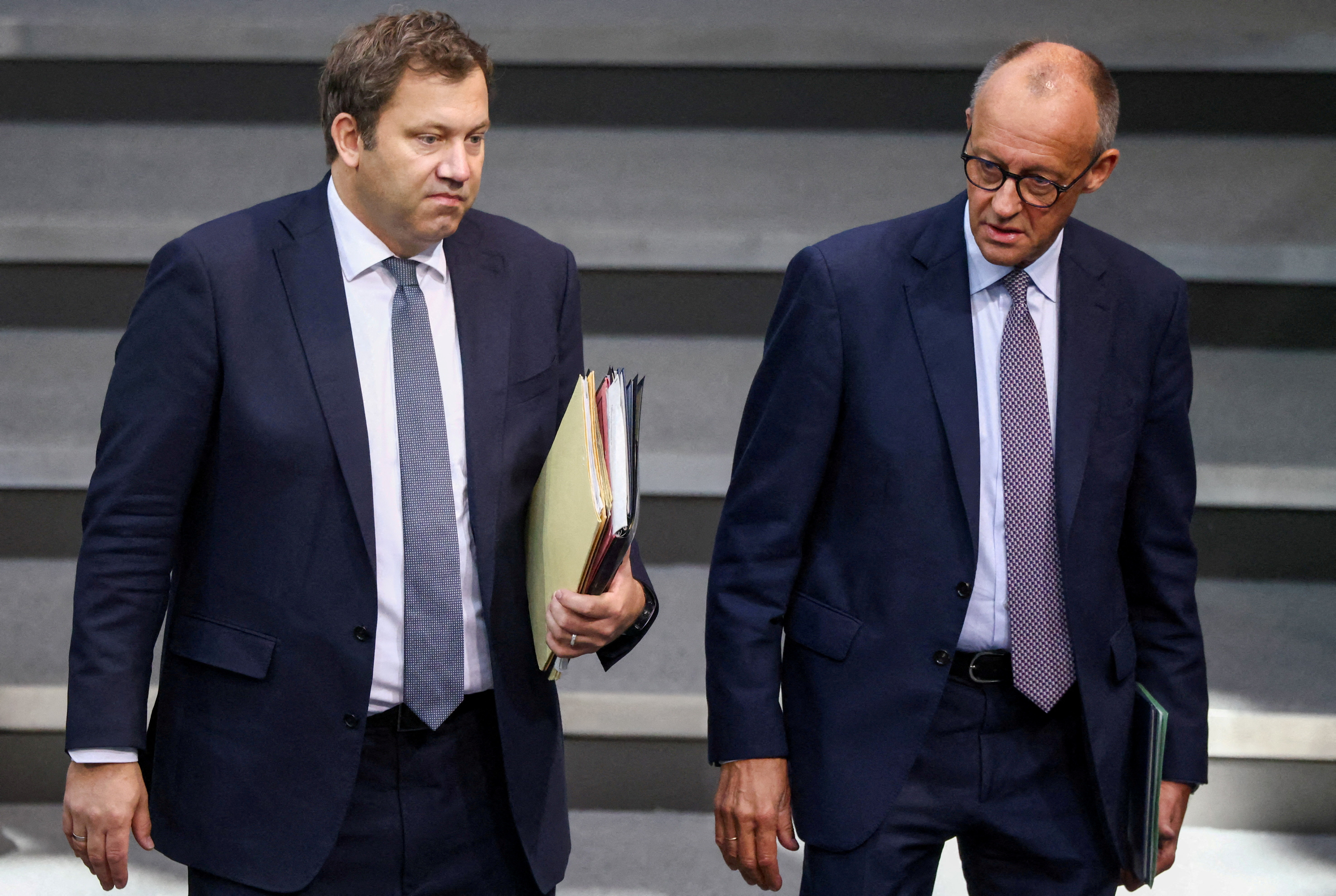 FILE PHOTO: German Chancellor Merz and Finance Minister Klingbeil arrive for budget debate at the Bundestag in Berlin