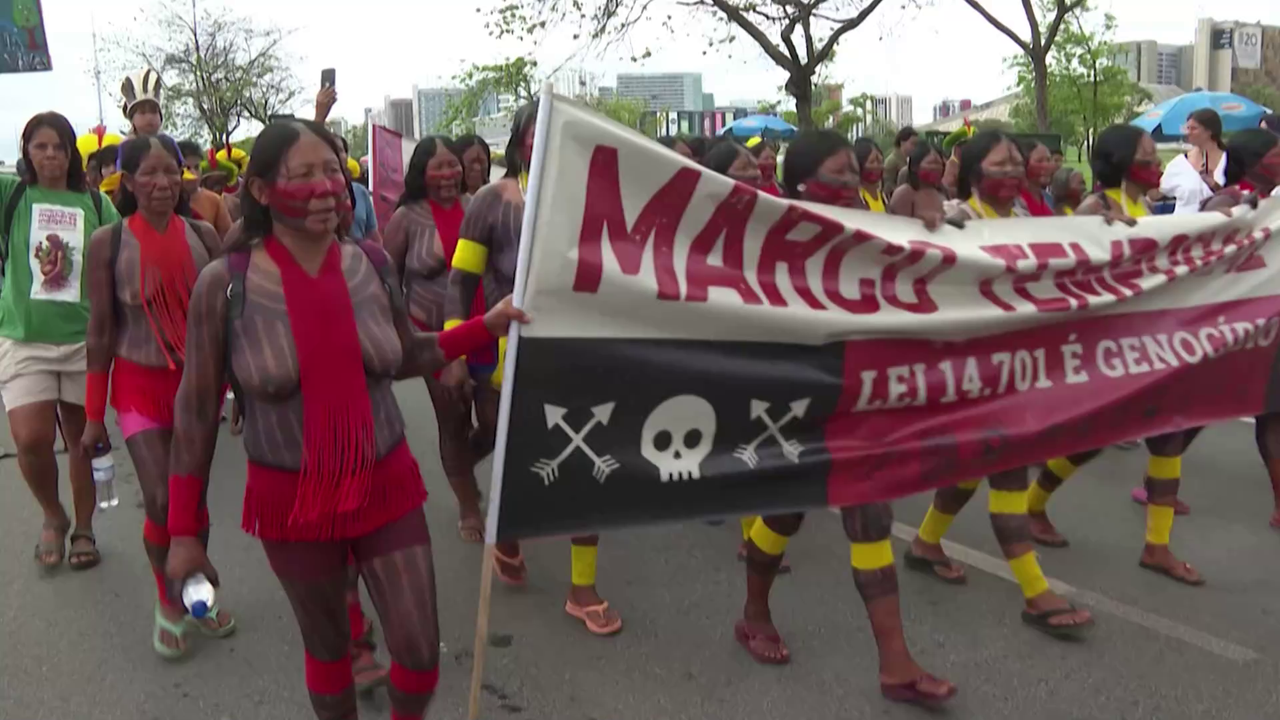 representatives from Indigenous communities march towards the Brazilian congress