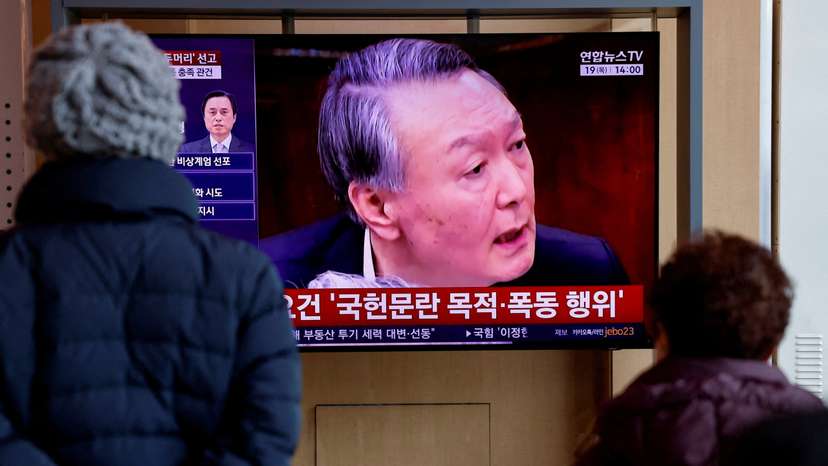 People watch a news report on the sentencing trial of South Korean former president Yoon Suk Yeol's insurrection case in Seoul